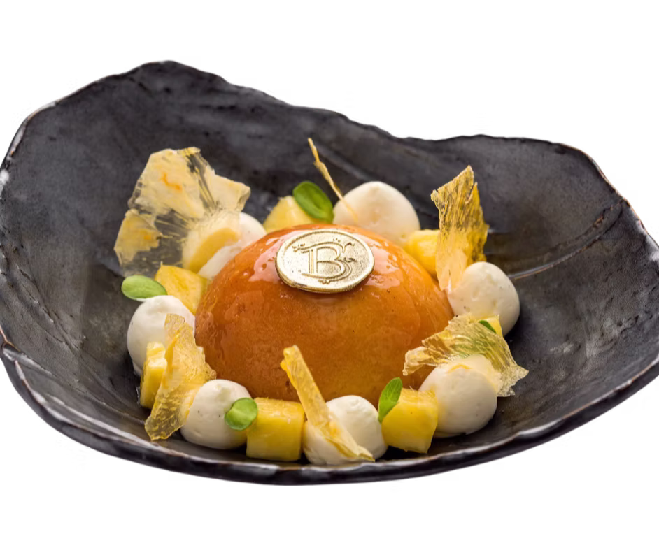 Plated dessert with a gold Bonito medallion